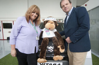 Corrina Sheridan of race sponsor SEQOL with Dominic Threlfall of Pebley Beach and race mascot Monty the Monkey. Pebley Beach supports the race by providing the lead car, fitted with the official race time clock